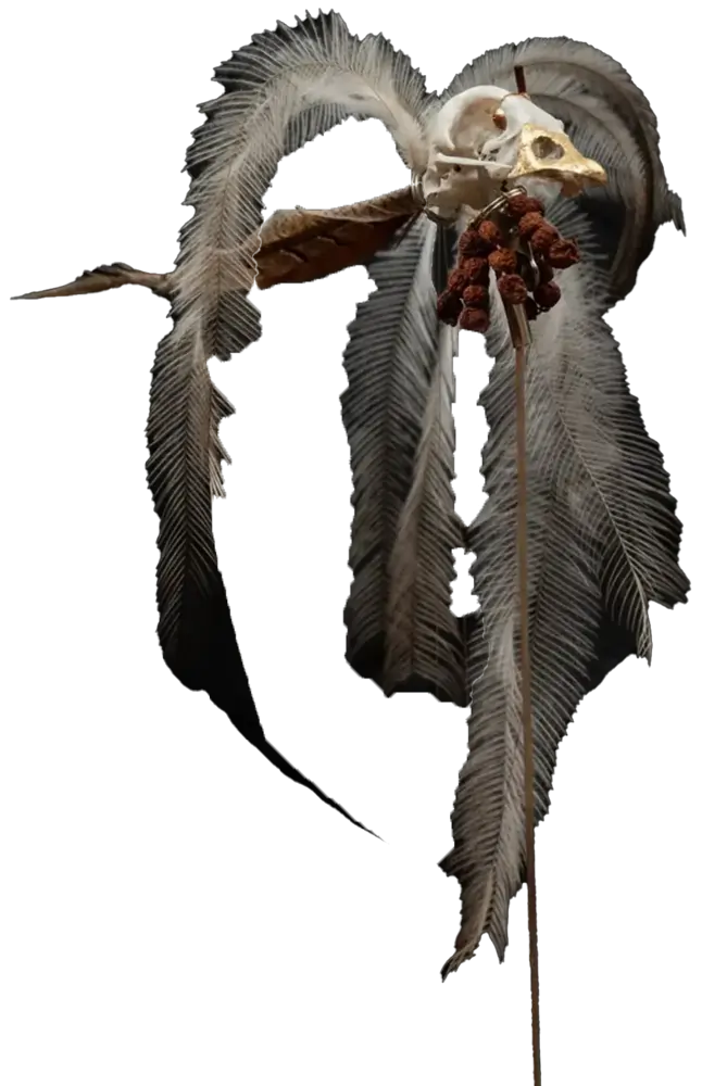 The Whisperer, a gilded skull with feathers and berries