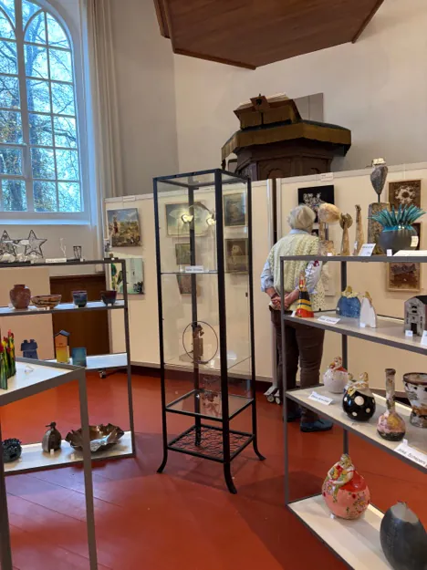 Interior of the Witte Kerk in Hemrik during Art Super, with vitrines and work by other artists